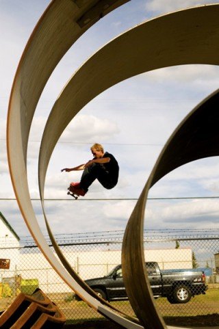 Chris Kendall performs an ollie while skateboarding