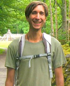 Jesse Bogdanovich wearing a green shirt and a backpack