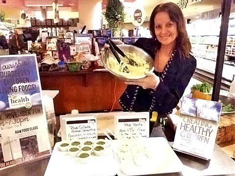 Karen Ranzi holds up a dish at a recipe demonstration
