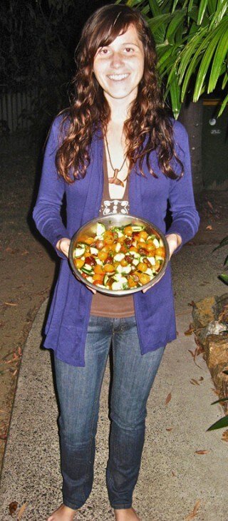 Tarah Millen holds a recipe in a bowl at night