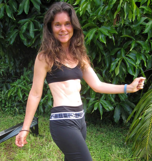 Janie Gardener smiles and poses with arms raised