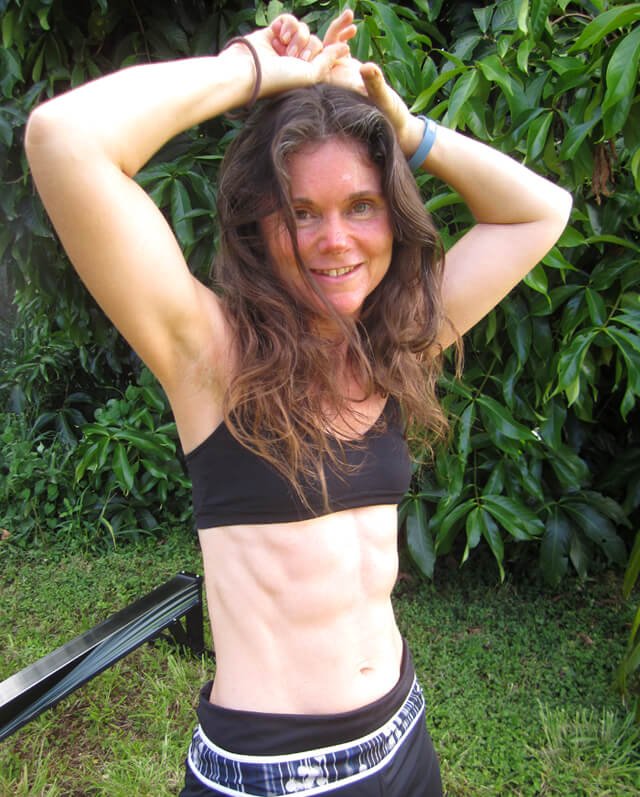Janie Gardener smiles and holds her hands above her head