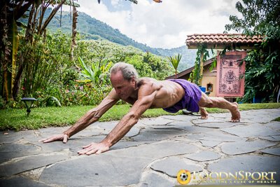 Dr. Doug Graham performs Superman pushups outside