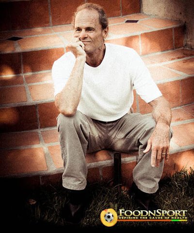 Dr. Doug Graham sits on steps with his hand on his chin