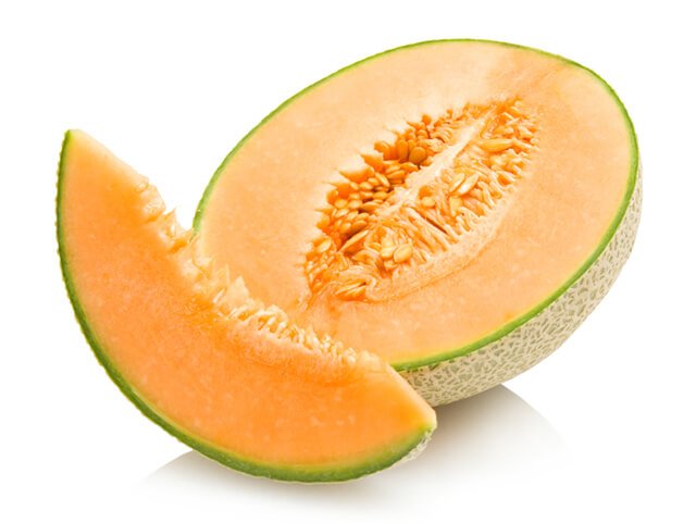 Cantaloupe sliced and halved against a white background
