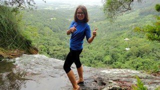 Elisa Oras gives thumbs-up on a mountain