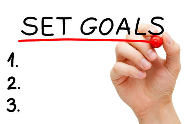 Woman writes her goals with a marker