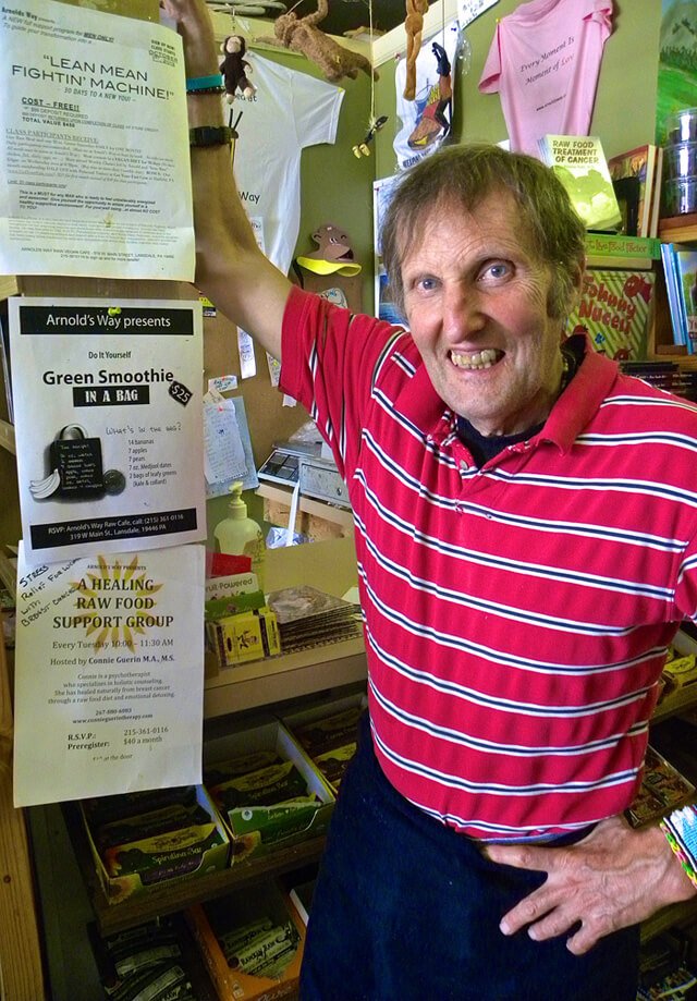 Arnold Kauffman smiles by the cash register at Arnold's Way