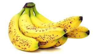 A hand of bananas against a white background