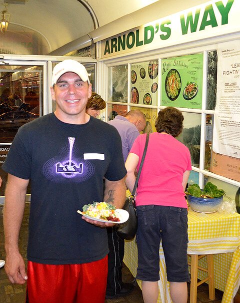 Charles Schmidt holds potluck food at Arnold's Way