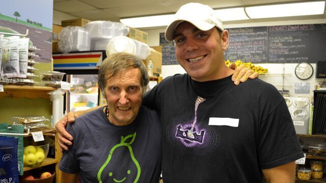 Charles Schmidt and Arnold Kauffman embrace and pose at Arnold's Way