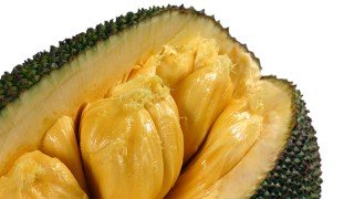 Jackfruit cut open against a white background
