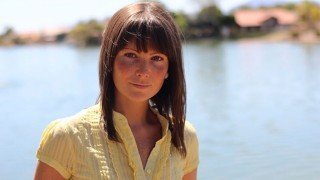 Megan Elizabeth outside by a lake