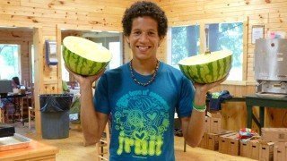 Kevin Rogers holds watermelon halves at The Woodstock Fruit Festival