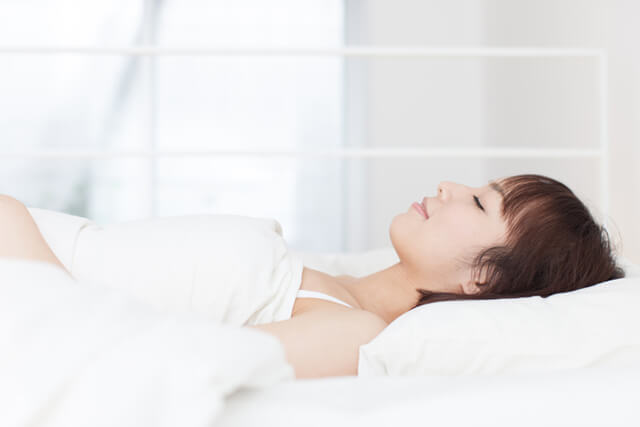 Asian woman at rest in bed