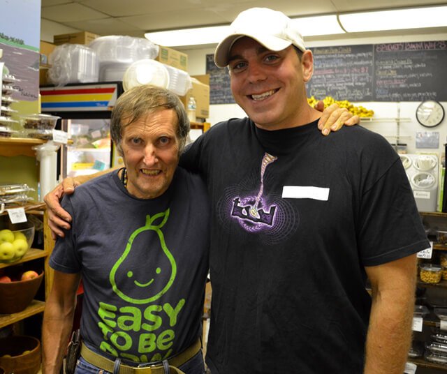 Charles Schmidt and Arnold Kauffman smile while hugging
