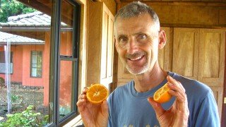 Don Weaver holding orange halves