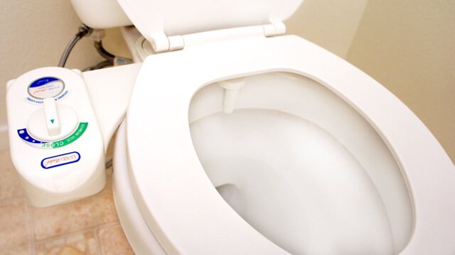 A LUXE bidet connected to a toilet