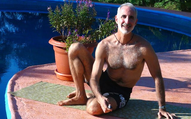 Loren Lockman sits next to a pool