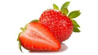 Strawberries whole and cut on a white background