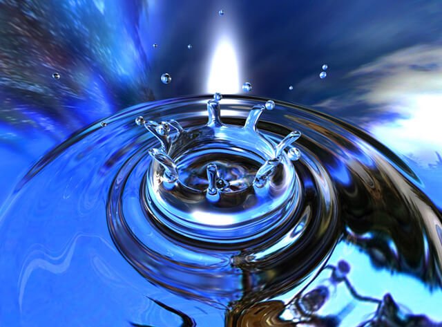 Water drops into a pool of water