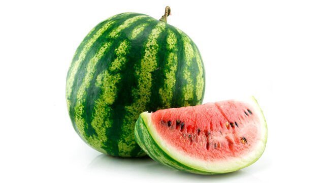 A whole watermelon and a large slice