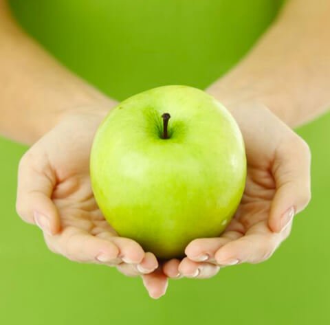 Granny Smith apple being held