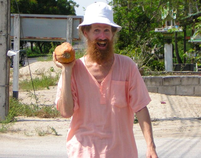 Jimmy Gilker raises a papaya with glee.