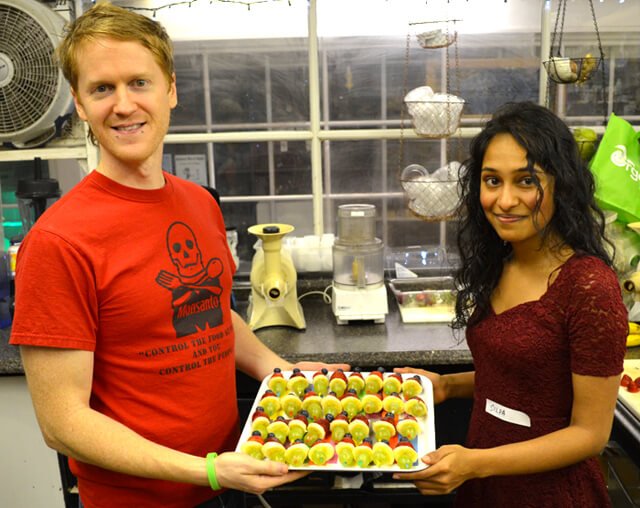 Silpa Reddy and Tim Radley hold Tim's meal contribution at the December 2013 potluck at Arnold's Way