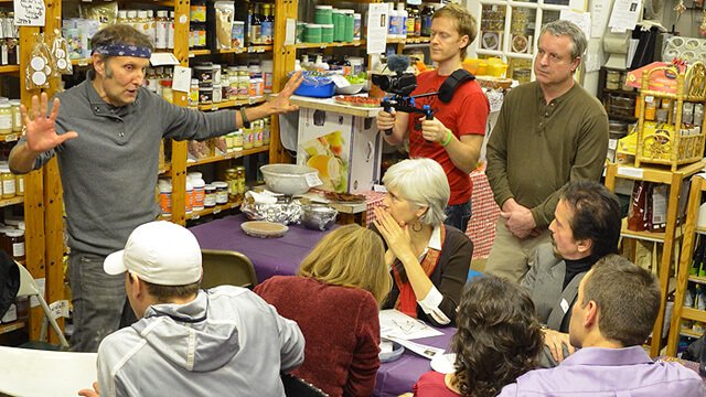Arnold Kauffman talks to guests at the December 2013 potluck at Arnold's Way