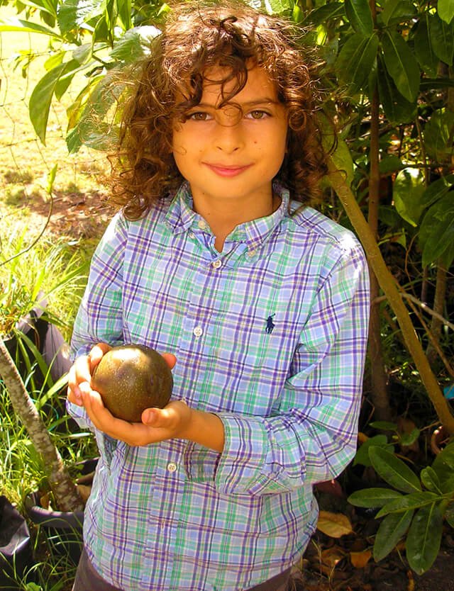 Cappi Osborne is photographed holding fruit
