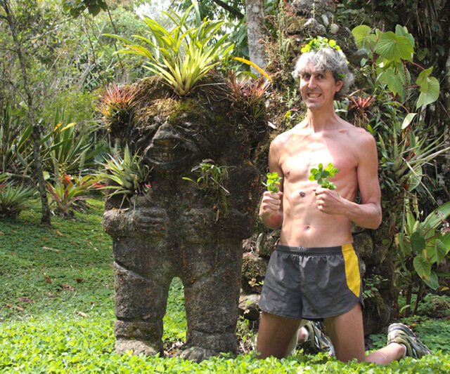 Grant Campbell smiles beside a statue