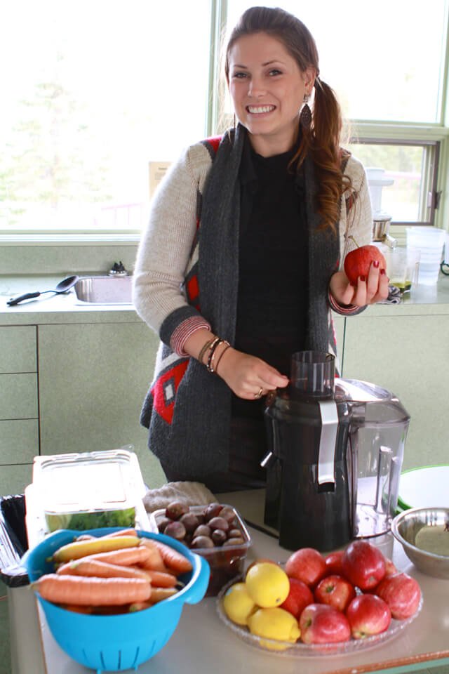 Ashley Clark in a kitchen with fruits and vegetables
