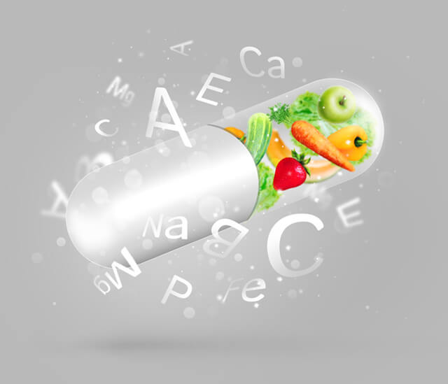 Fruits and vegetables in a vitamin capsule with vitamin names