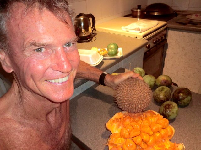 Robert Lockhart posing with durian and cempedak
