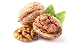 Dried walnuts against a white background