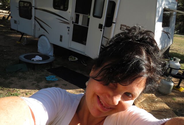 Joy King is photographed standing in front of her RV