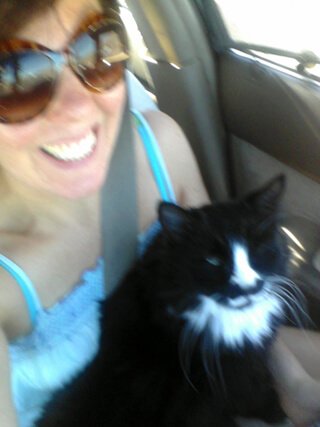 Joy King in her RV with her cat, Harley, on her lap