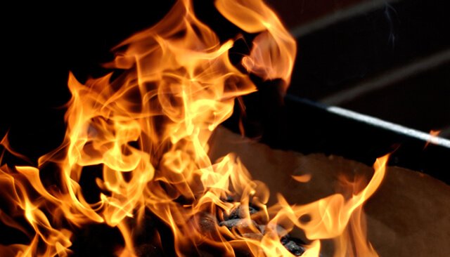 Roaring flame over a barbecue grill