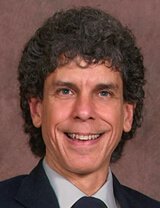 Headshot of Don Bennett, wearing a suit and tie