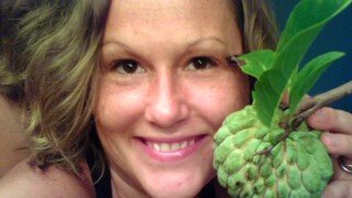 Closeup photograph of Tasha Lee holding fruit