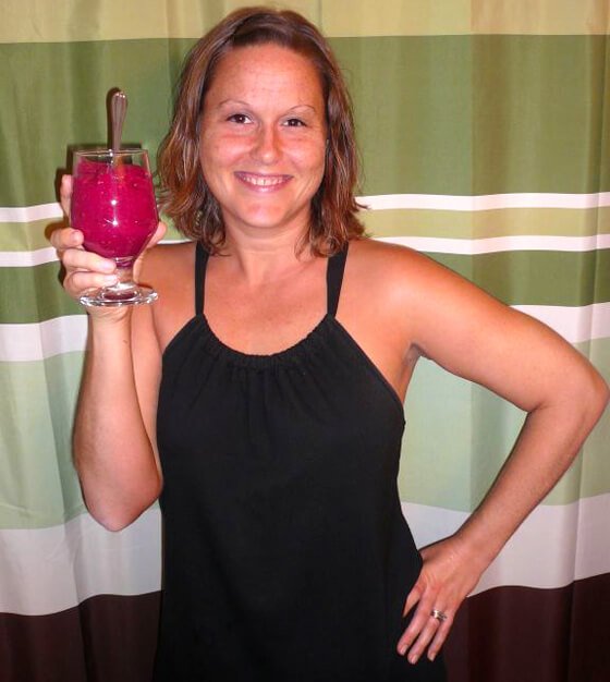 Tasha Lee holds a deep-red fruit meal in a glass