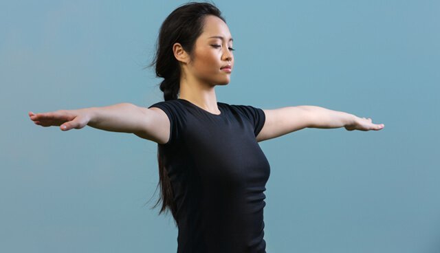 Chinese woman holding a yoga position