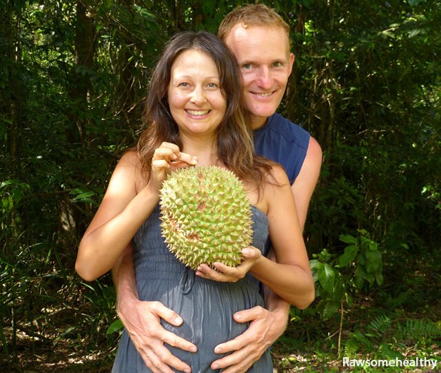 Yulia and Paul Tarbath holding a durian while pregnant