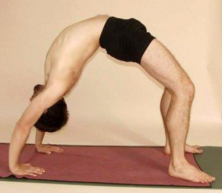 Benjamin Beeler performing the yoga pose full wheel