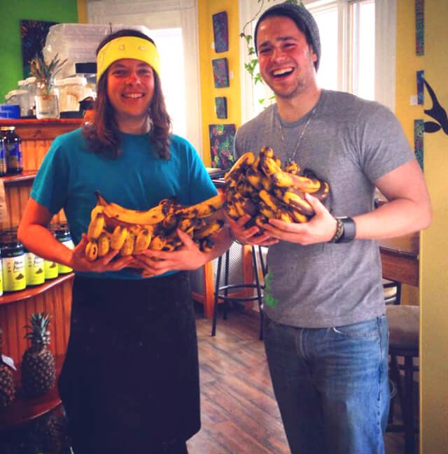 Dan McGrogan and a customer holding bananas after eating 30 each