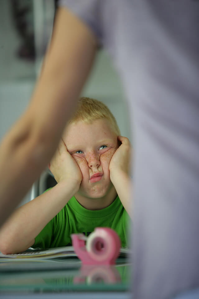 Boy looking frustrated in a classroom