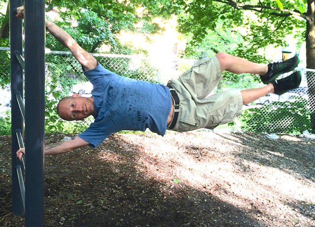 Rob "Freedomfighter" Rehnmark hangs sideways from beams