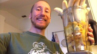 Rob Rehnmark showing a blender container full of bananas and mangos