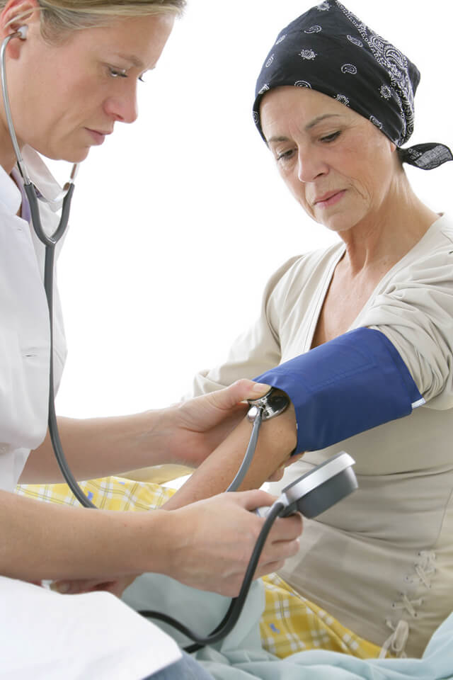 A doctor takes a woman's pulse